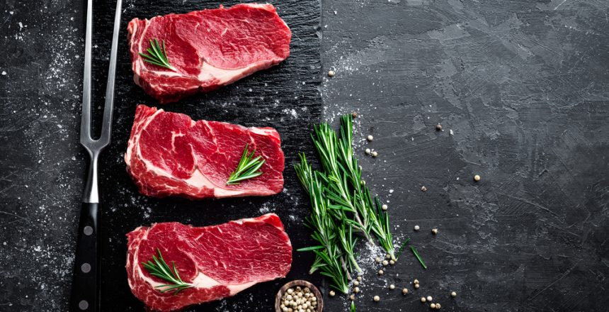 Raw meat, beef steak on black background, top view